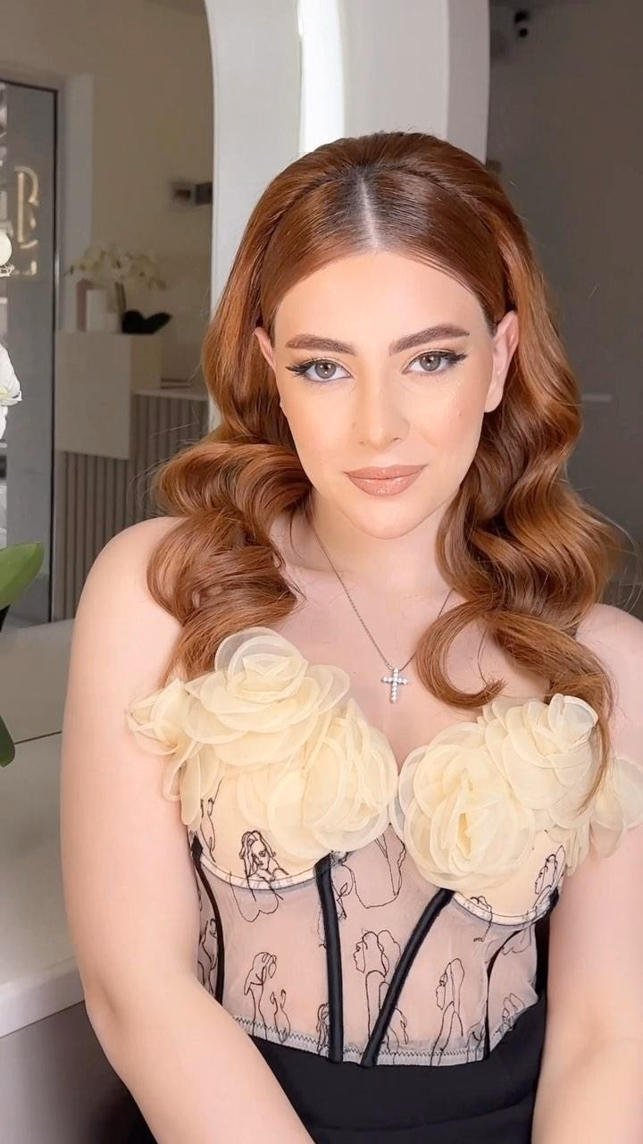 Bride with soft copper Hollywood waves, warm neutral eye makeup and a glossy nude lip